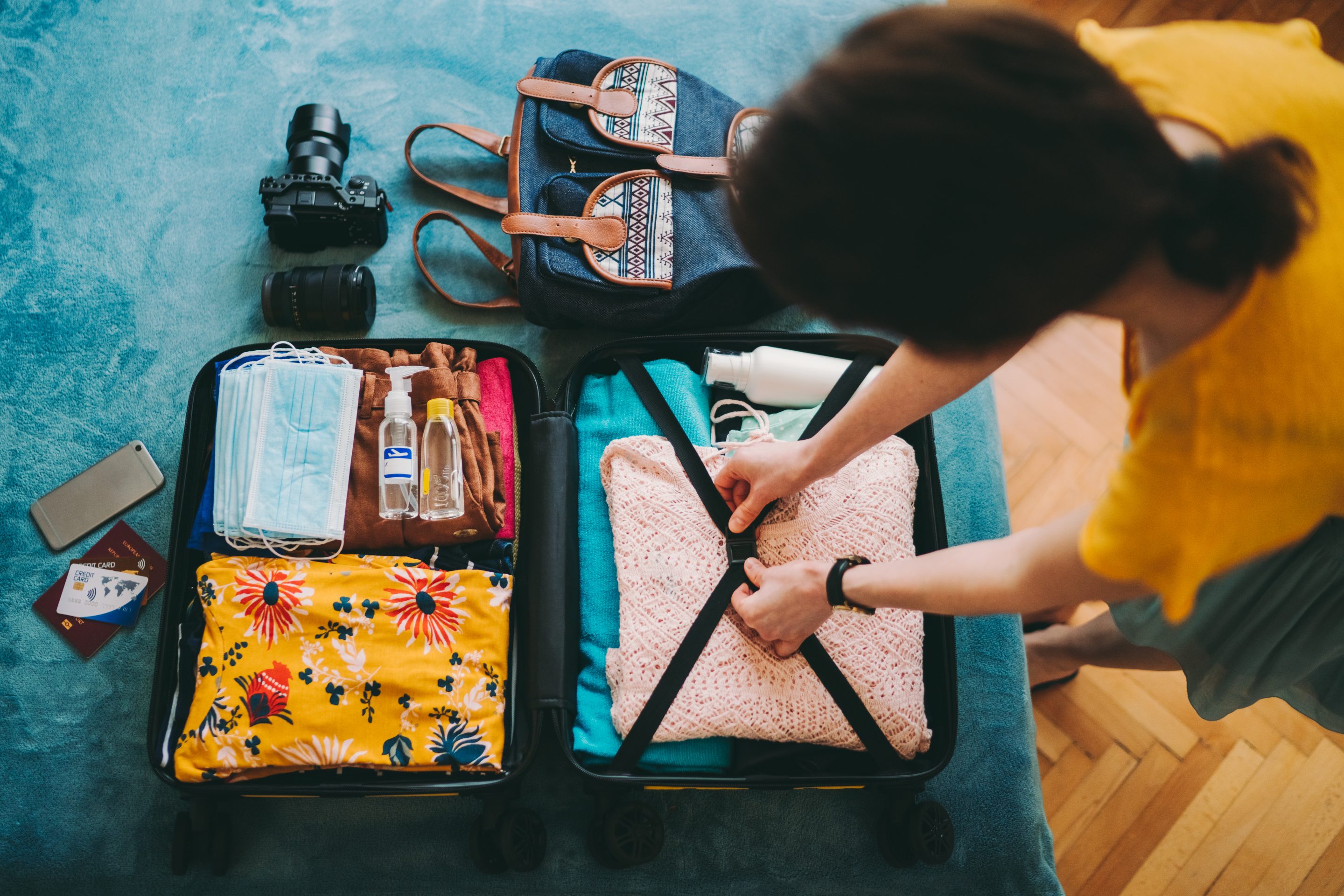 Woman packing suitcase for travel.