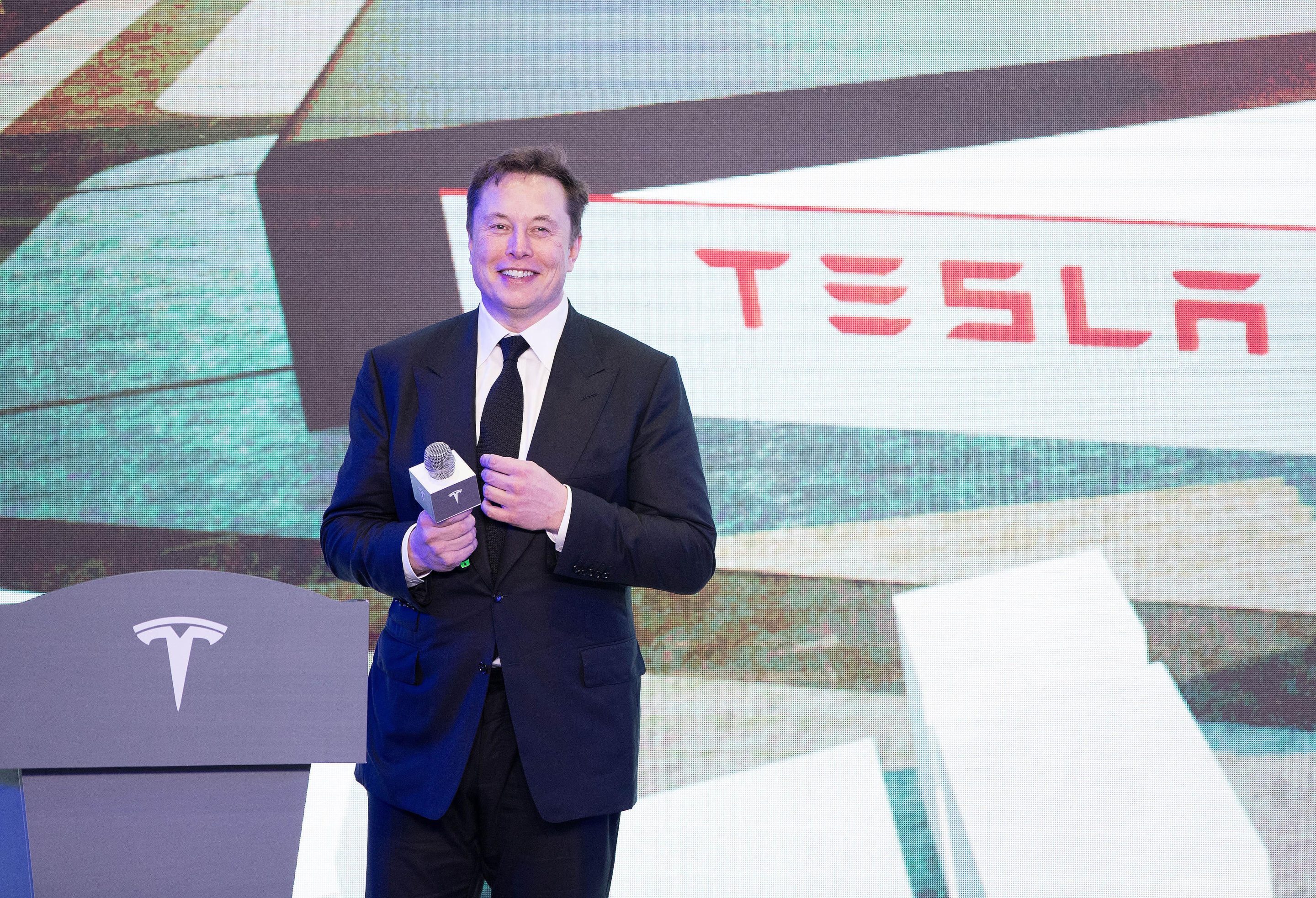 Elon Musk standing on stage