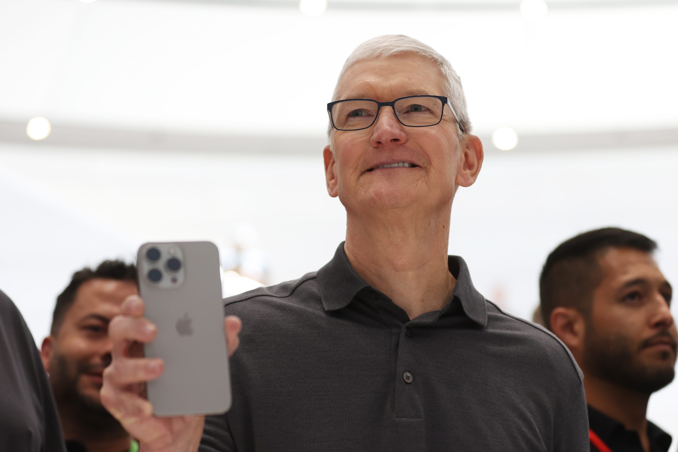 Apple CEO Tim Cook holds iPhone 15