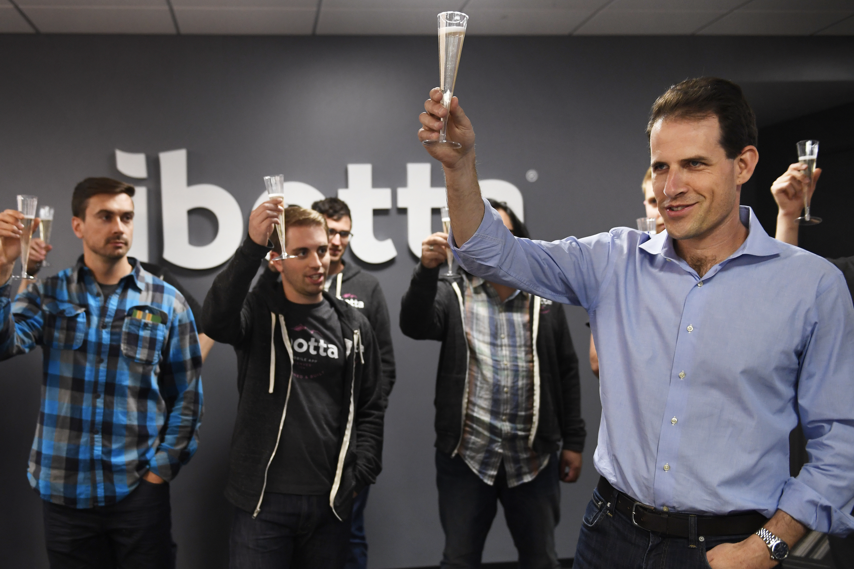 DENVER, CO - MAY 23: Ibotta&#039;s founder and CEO Bryan Leach raises his glass for a toast to the product and engineering team of Denver&#039;s well-known startup&#039;s relaunch of their mobile app. The complete overhaul of their mobile application took over 9 months and focused on user accessibility after more than 1,000 usability tests.  May 23, 2017 in Denver, Colorado. (Photo by Joe Amon/The Denver Post via Getty Images)